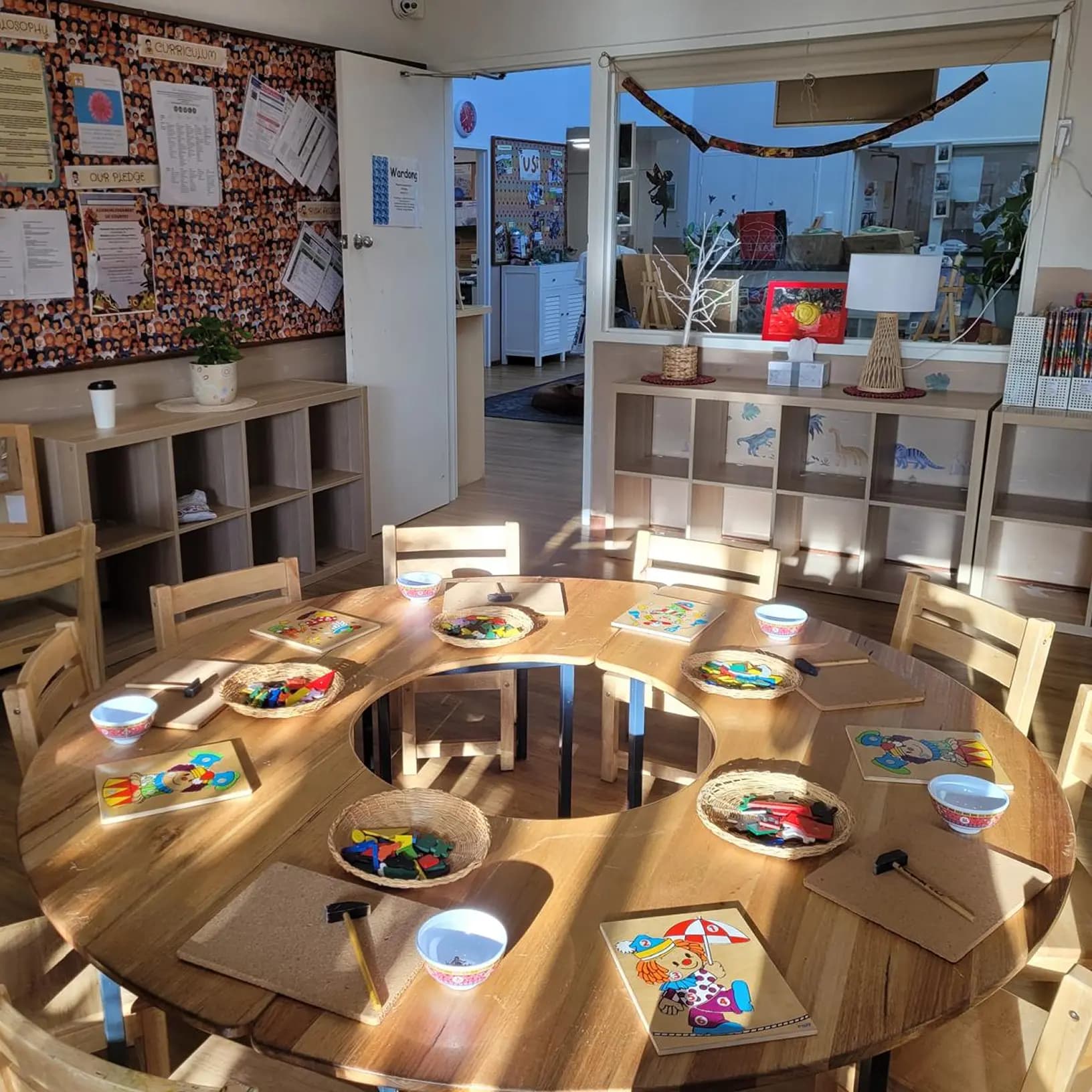 Warm, sunlit Moolanda childcare classroom showing an open layout with drawing books and learning tools arranged for quality early childhood education