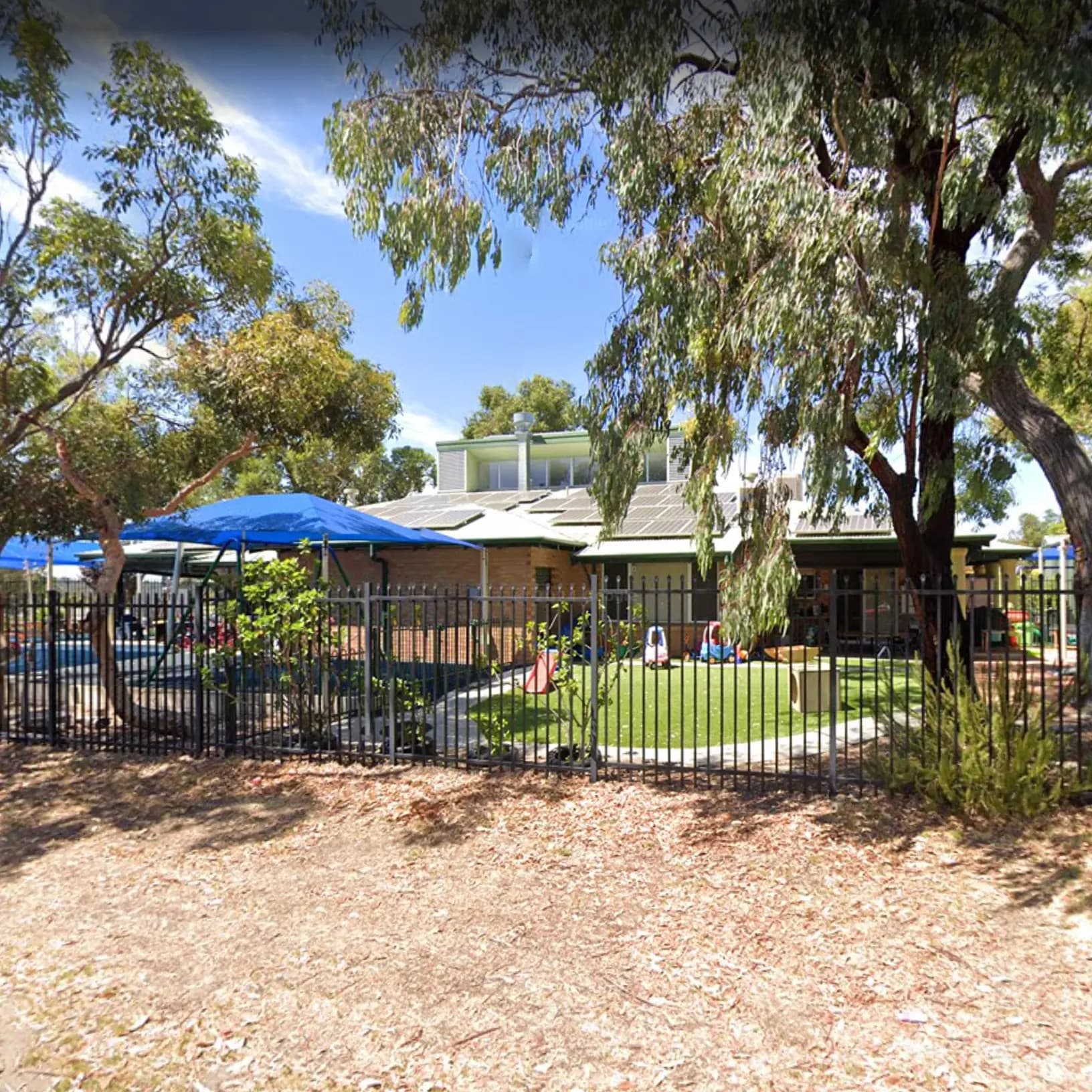 Exterior view of Moolanda, a community-based early childhood centre, featuring the building and large playground captured from the street.